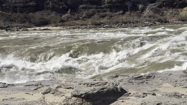 Turbulent, magnificent Yellow River in early spring, sunny day.