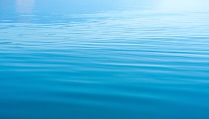 Obraz premium Calm bright blue water surface background texture with gentle ripples