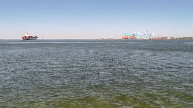 Aerial view of shipping containers and industrial port cranes on the Elizabeth River in Norfolk Virginia waterfront