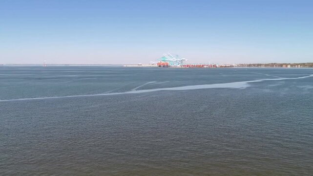 Aerial view of shipping containers and industrial port cranes on the Elizabeth River in Norfolk Virginia waterfront