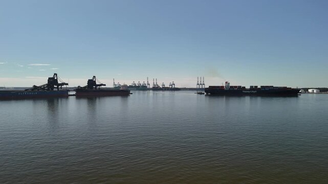 Aerial view of shipping containers and industrial port cranes on the Elizabeth River in Norfolk Virginia waterfront