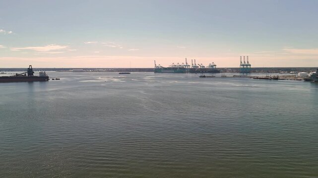 Aerial view of shipping containers and industrial port cranes on the Elizabeth River in Norfolk Virginia waterfront