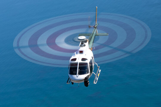 Helicopter (Eurocopter AS350)  over the Pacific ocean at very low shutter speed