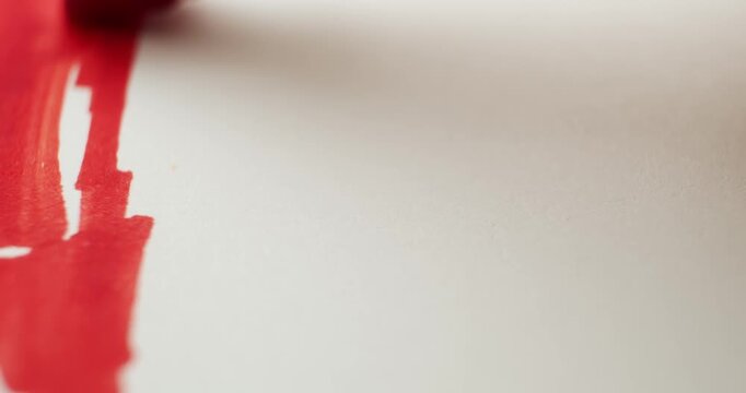 Close up of coloring a rainbow with markers on plain white paper. Celebrating pride month with bright ink colors creating a hand drawn rainbow flag.