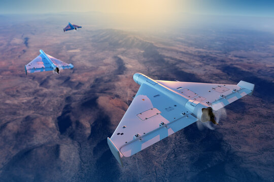 Military aviation, Shahed loitering munition drones flying in formation above desert landscape, unmanned combat aircraft performing reconnaissance and strike mission operations