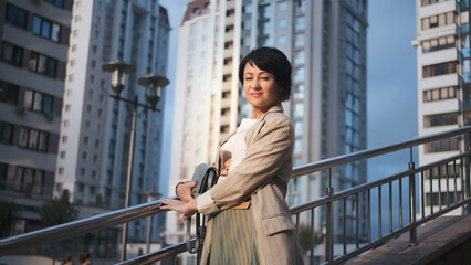 woman posing outdoors in modern urban environment