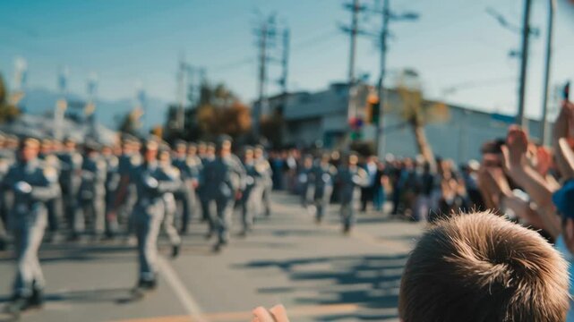 Child watching military parade while waving hands in city street  