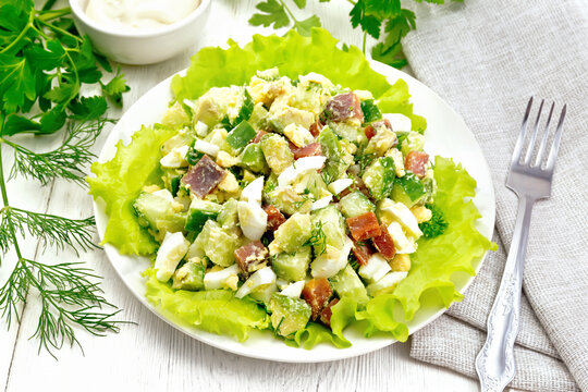 Salad of salmon and avocado on white board