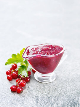 Sauce of redcurrant on stone table