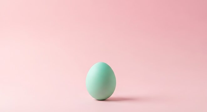 A single pastel blue egg centered on a soft pink background, symbolizing Easter and new beginnings