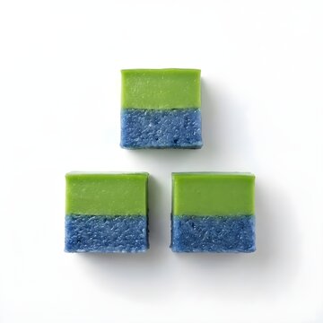 Three Seri Muka squares featuring blue-pea rice layers and smooth green pandan custard with glossy finish