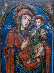 Naklejka premium An old style painted icon depicting the Virgin Mary with the baby Jesus in her arms, at the Sambata de Sus monastery - Romania