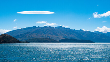 ruby island wanaka beautiful scenery landscape views lake blue water clear blue sky mountains trees lush green stunning iconic new zealand