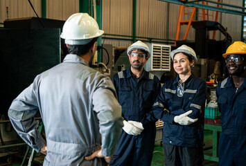 Factory supervisor leading team meeting with industrial workers on production floor, leadership communication and manufacturing workforce management concept © DJ Creative Studio
