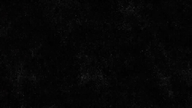 Dark abstract grunge texture with subtle dust and noise particles on black background. Useful as background for video overlay, cinematic effect, horror theme, digital design, wallpaper, or atmospheric