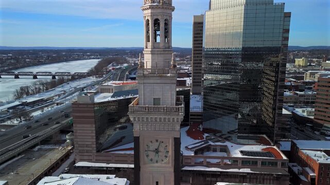 Drone close view of Springfield clock tower with skyline and river