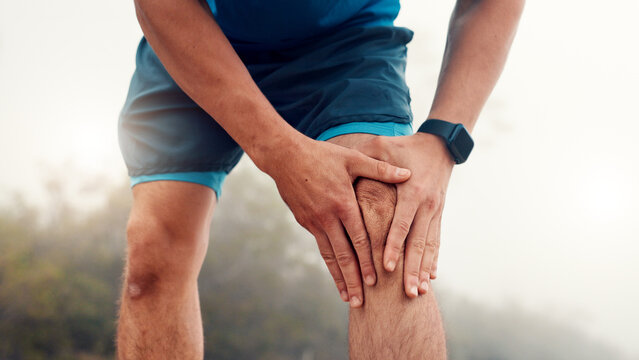 Man, hands and fitness with knee injury for workout accident, sprain or pressure in nature. Active, male person or runner with sore leg, joint inflammation or muscle tension for exercise or training
