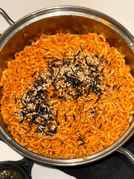 Spicy and flavorful buldak topped with melted cheddar cheese, creating a rich and creamy contrast to the intense heat. A perfect balance of bold spice and cheesy indulgence for a satisfying meal.