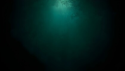 Obraz premium A dark and mysterious underwater scene with a beam of light shining down from above