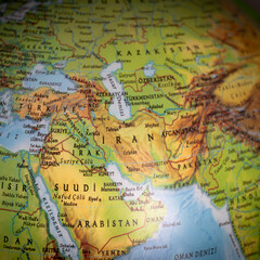 Obraz premium Political tension in the Middle East. A world map focused on Iran. The United States and Israel declared war on Iran. Economic and oil crises caused by the war. Countries and borders. Top view, above,