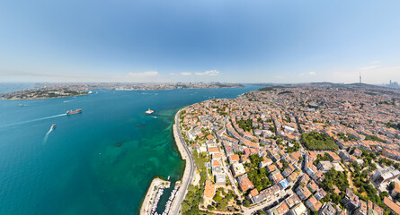 Obraz premium Istanbul, Turkey. Bosphorus strait with Maiden's Tower, dry bulk carrier in Golden Horn, and districts of Fatih, Uskudar, Beyoglu. Aerial view of maritime traffic at summer midday. Aerial view.