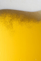 Beer. Jet of beer is poured into a beer glass, causing a lot of bubbles and foam