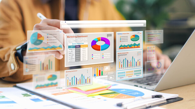 Business professional analyzing marketing dashboard with data charts on laptop and tablet. Concept of data analytics, business intelligence, and strategy.