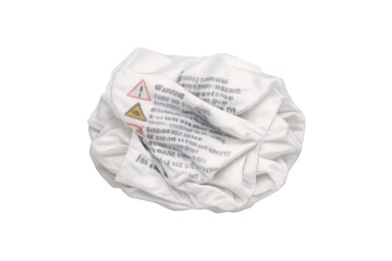 Crumpled white warning label textile waste recycling concept