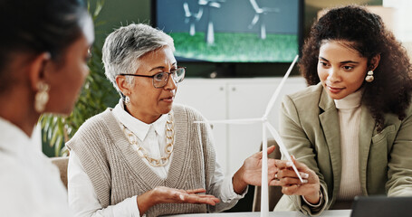 Wind turbine, office and business women with discussion, eco friendly project or clean energy....