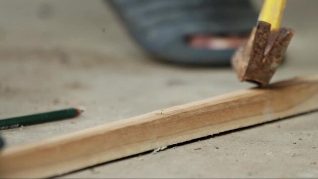 Close Up Removing Nail From Wood With Claw Hammer. Carpentry Work Removing Nail From Timber