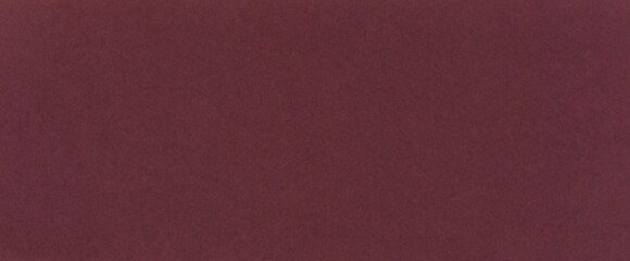 Fototapeta premium Dark red paper background with noble wine hue. Burgundy color textured surface with fine grain for design cover, branding, presentation, template, flyers, poster, elegant designs