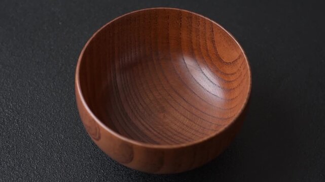 An empty round brown wooden bowl for Asian food. An empty wooden bowl as a food background for your design