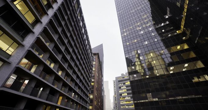 twilight urban canyon with reflective black tower and lit masonry windows, imagined drone corridor cutting through city fabric, moody sky, cinematic angle ideal