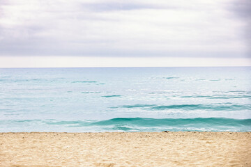 Obraz premium Empty sand beach by the sea with a view against the horizon