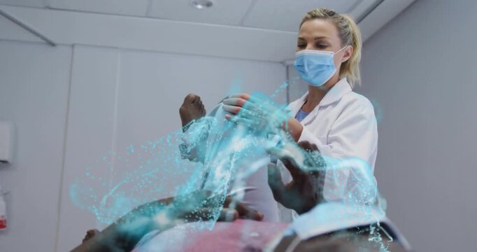 Clinician placing hands on knee, flexing leg, causing blue AR overlay on torso or leg for medical ex