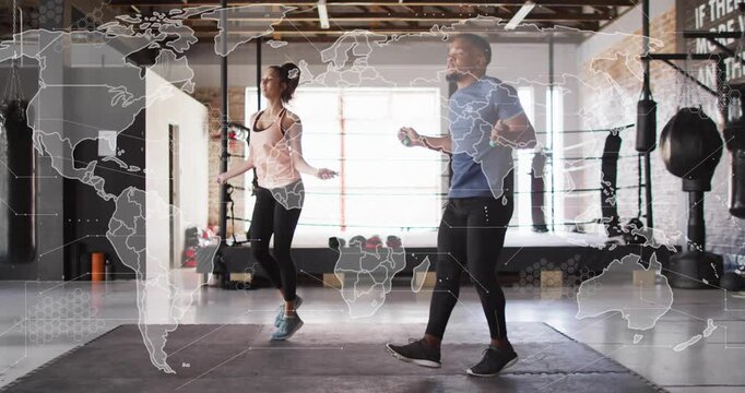 Workout partners starting rope swing, syncing skips on mat for cardio, map overlay spanning frame