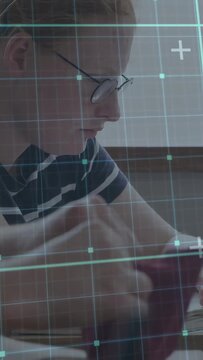 Vertical video: Teen reaching for purple pouch, writing in book for study, teal HUD overlaying desk