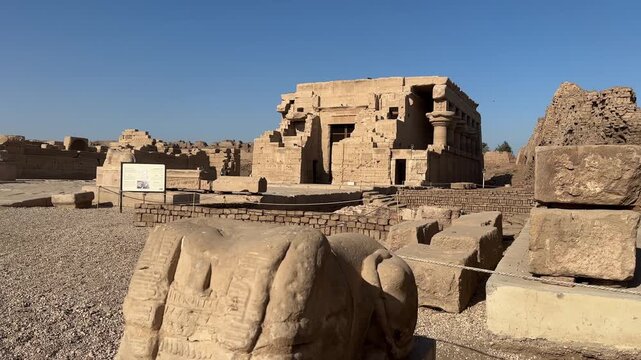 Wide view of the Roman Mammisi or Birth House at the Dendera Temple complex in Egypt featuring ancient stone structures and ruins
