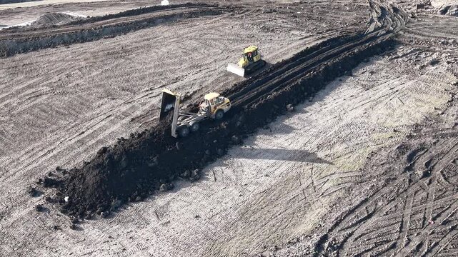 Truck dumps load Rainham Landfill site Essex UK drone,aerial