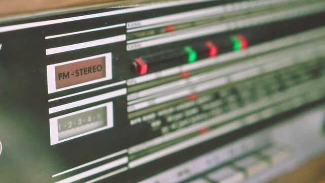 Pull focus revealing radiogram radio frequency panel listing European broadcast cities. Suitable for communication history and retro electronics visuals.