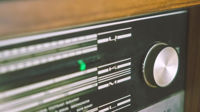 Pull focus close-up revealing radiogram control panel and frequency indicators. Suitable for vintage audio technology, broadcasting equipment and retro electronics visuals.