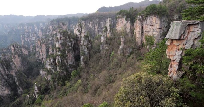 Stunning panoramic pan of West Sea sandstone pillars at Tianzi Mountain, Zhangjiajie, camera turn right, revealing Training Horses by Warrior rock formation. Soft illuminated landscape after sunset