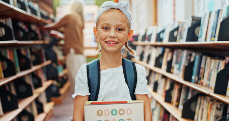 Education, portrait and smile of girl in library for child development, literature or study. Books, learning and reading assignment with happy student at school for future, information or knowledge