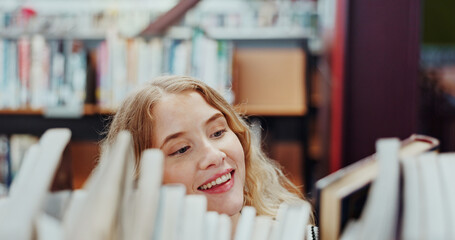 Obraz premium Student, girl and search on bookshelf at university for book choice, pick textbook or knowledge. Campus, happy person or check course resources in library for study research, thesis citation or above