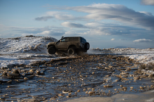 Car on an icy road keeps you moving. Car in winter weather looks tough. Car on rough terrain takes you farther. Car under big skies makes you feel free.