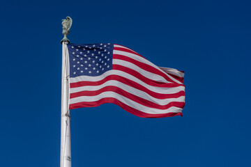 Obraz premium Flag American waving in sky background. American patriotic liberty banner on flag. USA democracy freedom symbol in flag. American culture independence on flag.