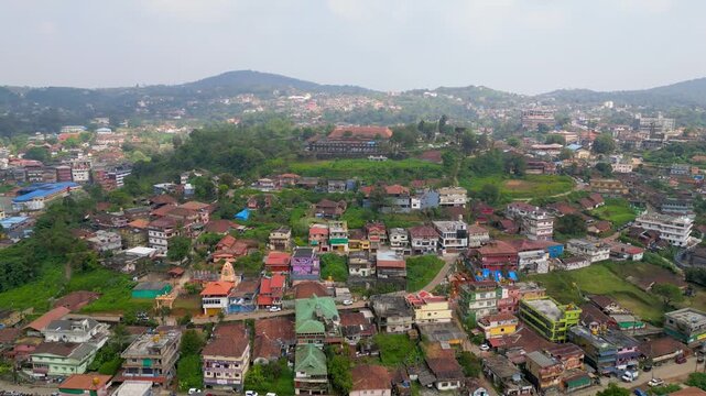 Aerial view of Madikeri cityscape with its colorful houses, lush greenery tropical landscape in India.