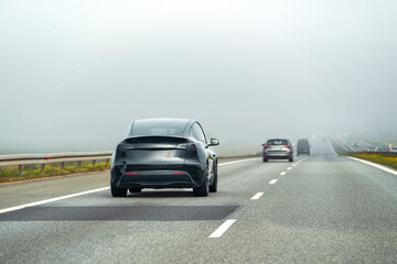 Electric SUV on quiet road surrounded by nature