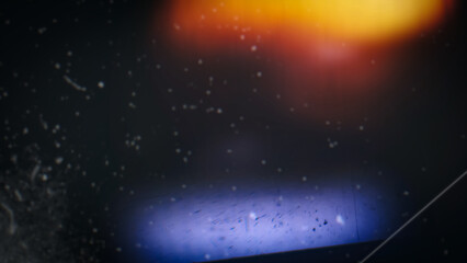 Obraz premium Abstract distressed film burn texture with warm light leak, scratches, dust, and dark vintage gradient. Retro photo overlay background design