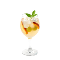 Refreshing white sangria with white wine, peach slices, berries and mint in a glass pitcher